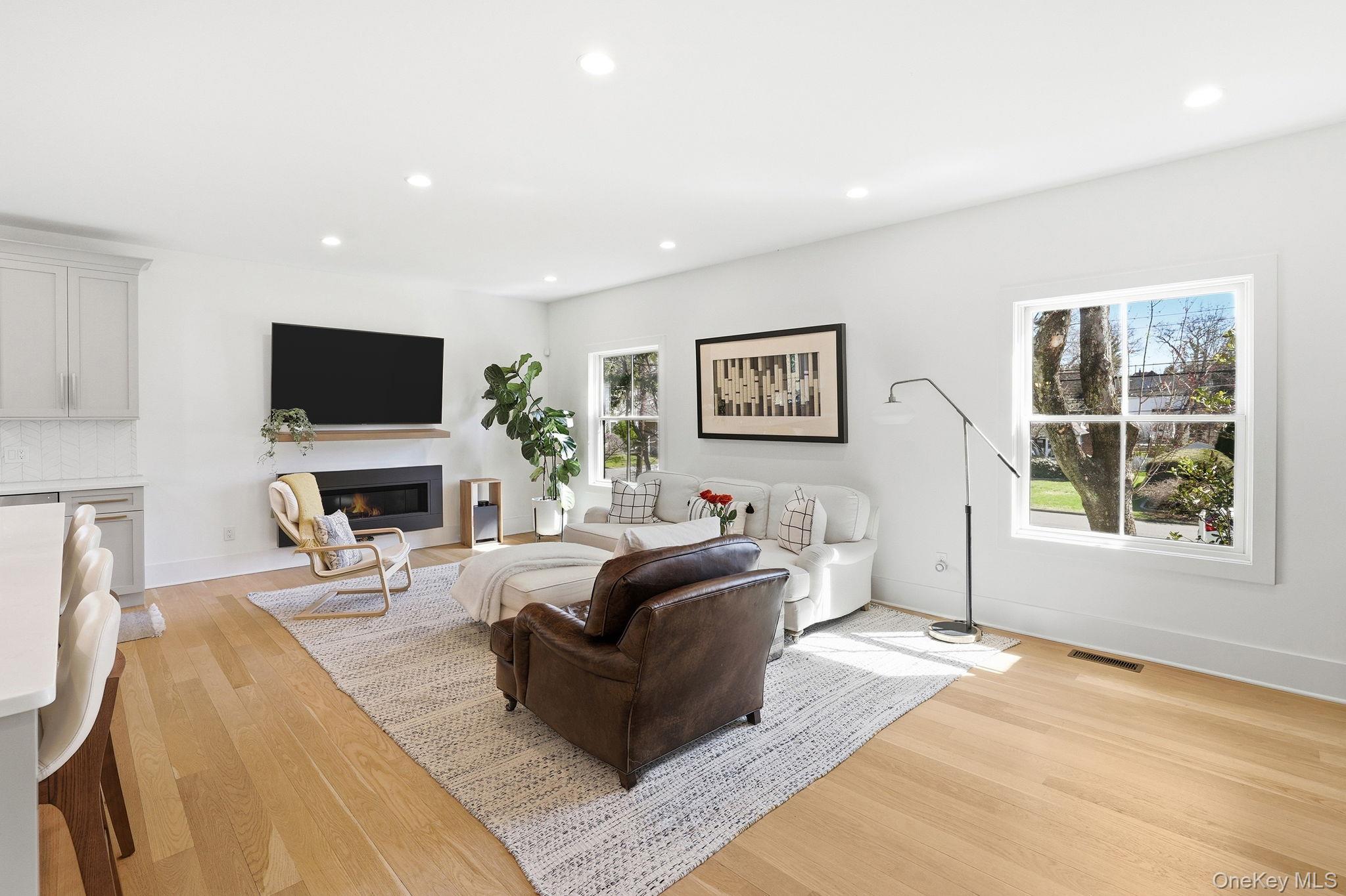 72 Valley Terrace Rye Brook, NY 10573 - Photo 11 of 32 a living room with furniture a fireplace and a flat screen tv