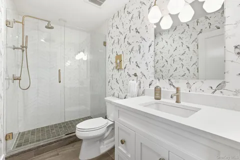 a bathroom with a sink toilet and shower
