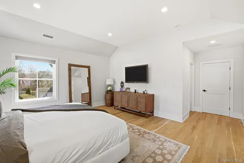 a bedroom with a bed and a flat screen tv
