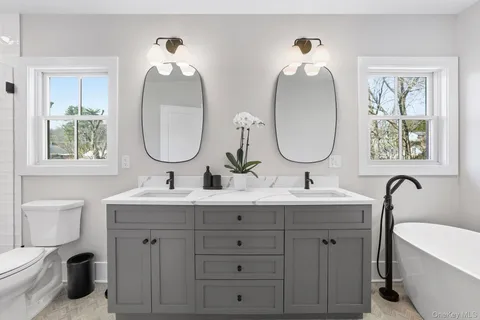 a bathroom with a double vanity sink and a mirror