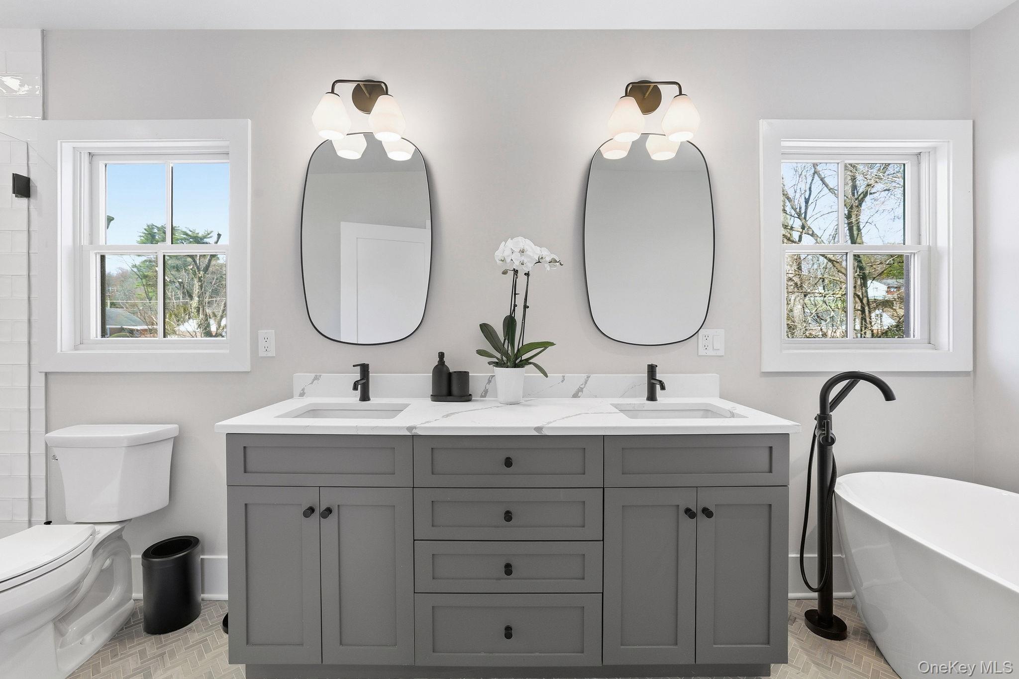 72 Valley Terrace Rye Brook, NY 10573 - Photo 17 of 32 a bathroom with a double vanity sink and a mirror