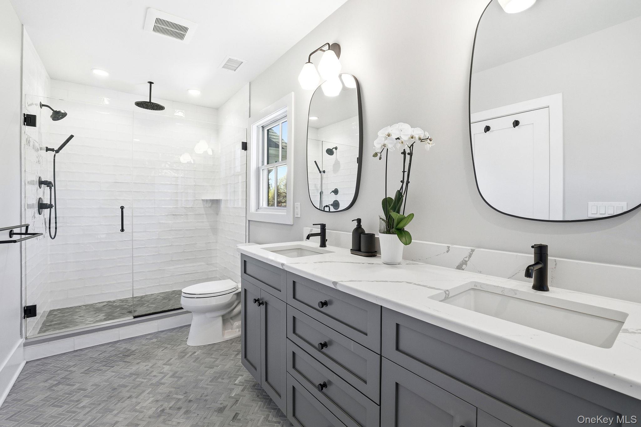 72 Valley Terrace Rye Brook, NY 10573 - Photo 18 of 32 a bathroom with a double vanity sink mirror and toilet