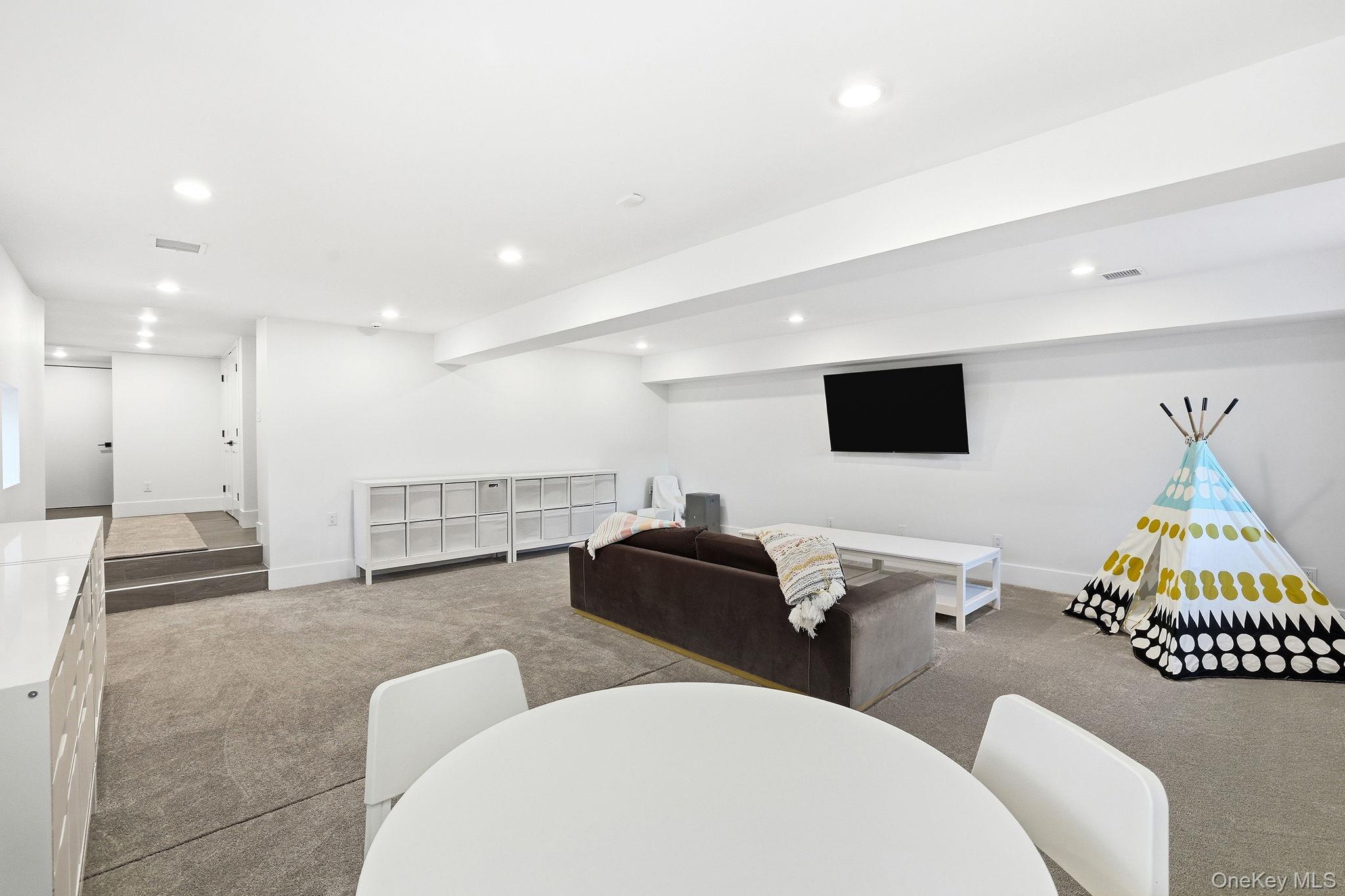 72 Valley Terrace Rye Brook, NY 10573 - Photo 25 of 32 a living room with furniture and a flat screen tv