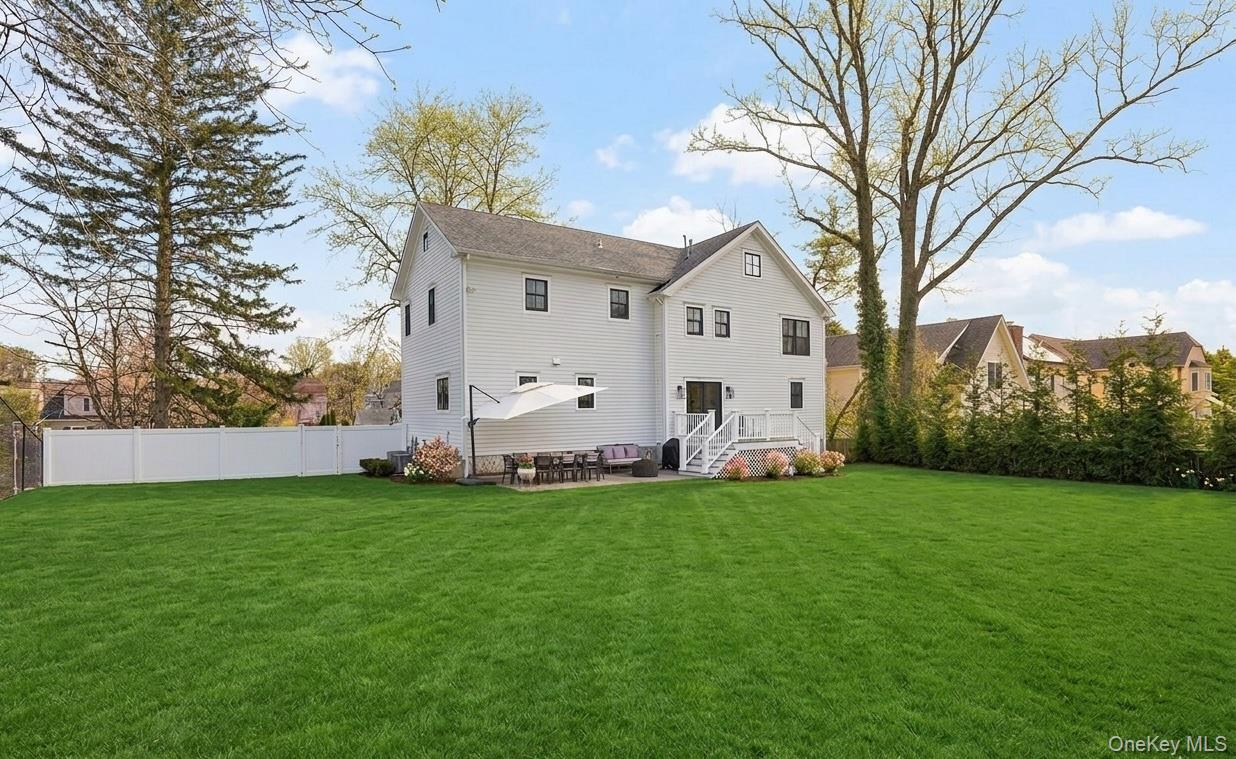 72 Valley Terrace Rye Brook, NY 10573 - Photo 27 of 32 a view of a white house with a big yard and large trees