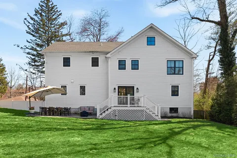 a front view of house with a garden