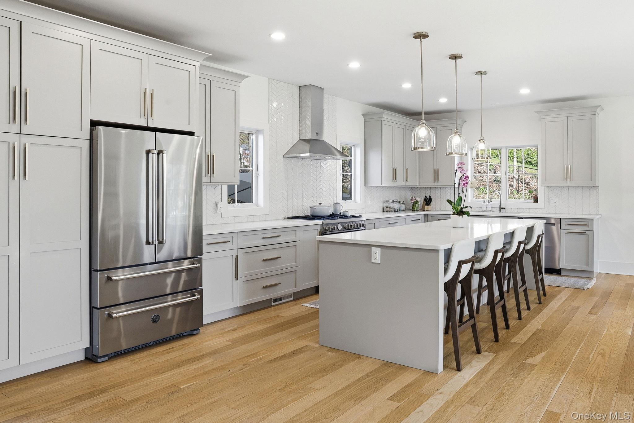 72 Valley Terrace Rye Brook, NY 10573 - Photo 8 of 32 a kitchen with kitchen island white cabinets and stainless steel appliances