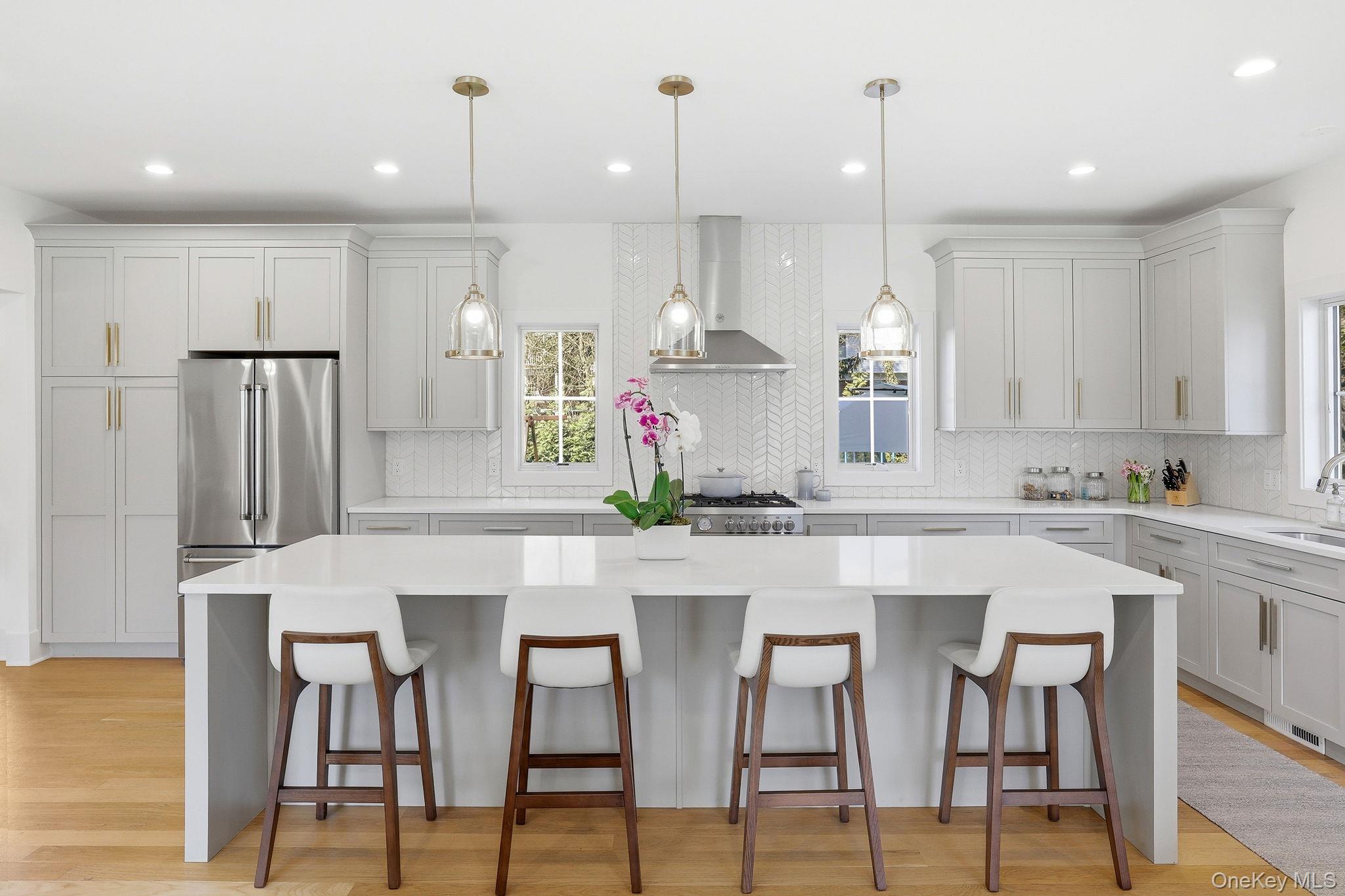 72 Valley Terrace Rye Brook, NY 10573 - Photo 9 of 32 a kitchen with kitchen island granite countertop a table and chairs in it