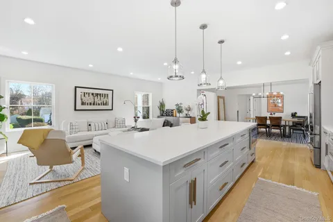 a large white kitchen with a large center island in it