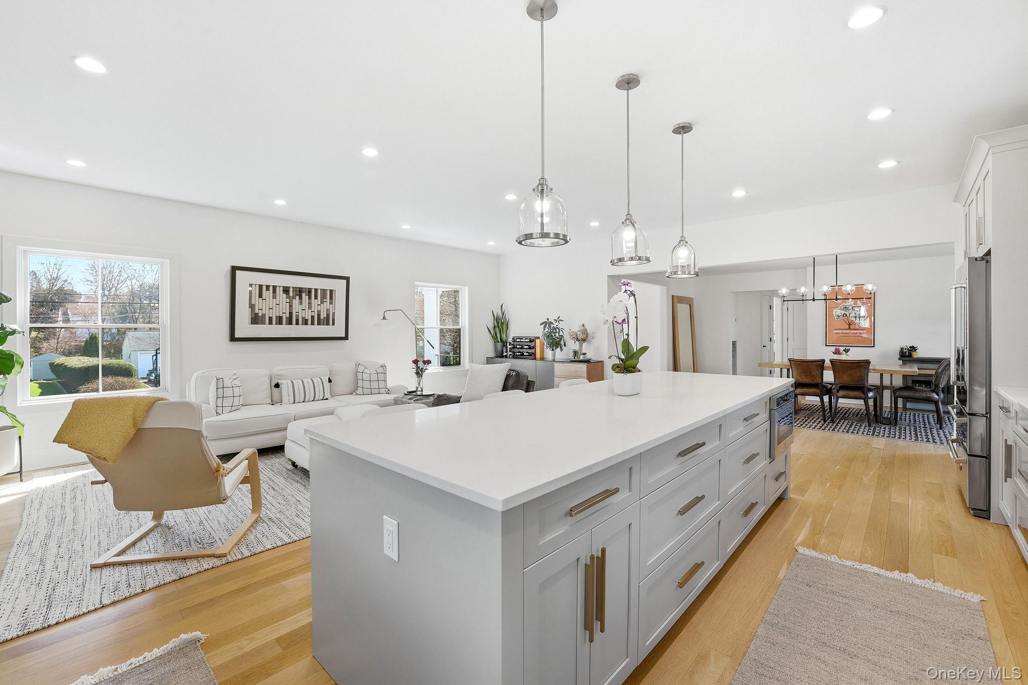 72 Valley Terrace Rye Brook, NY 10573 - Photo 10 of 32 a large white kitchen with a large center island in it