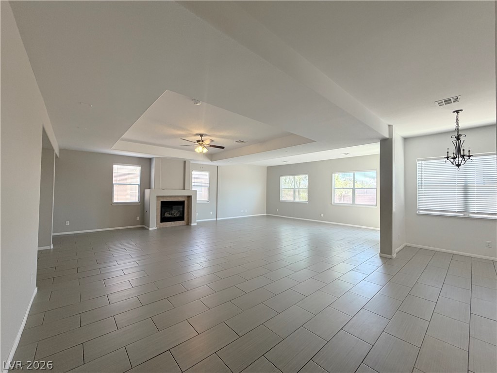 6116 Rabbit Track Street Las Vegas, NV 89130 - Photo 2 of 28 A spacious living area featuring a fireplace and sleek tile flooring.