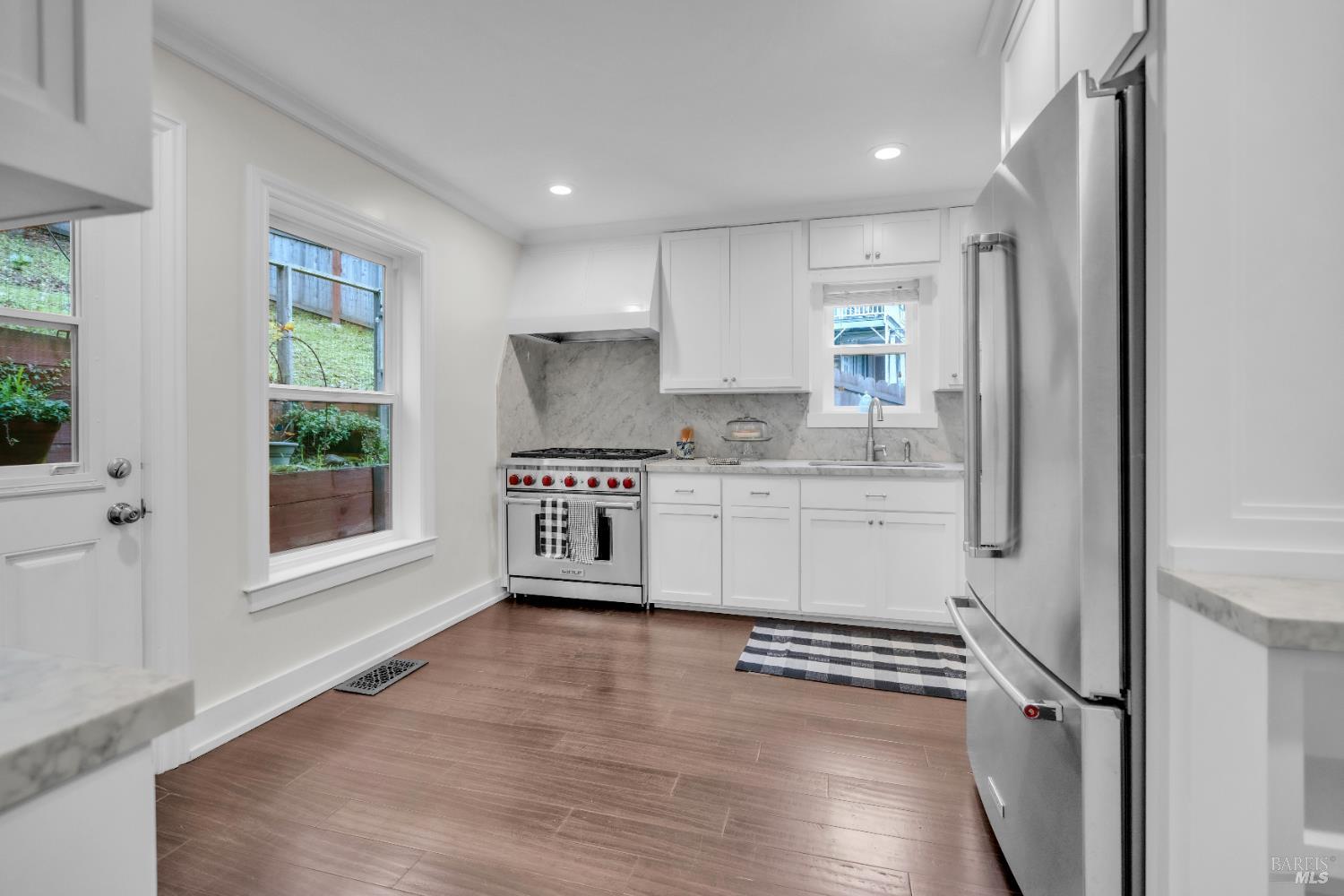 11 Jessup Street San Rafael, CA 94901 - Photo 7 of 54 a kitchen with white cabinets and white appliances