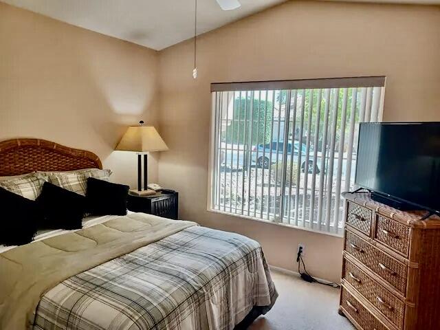 78376 Moongold Road Palm Desert, CA 92211 - Photo 10 of 36 a bedroom with a bed and a flat tv screen on dresser
