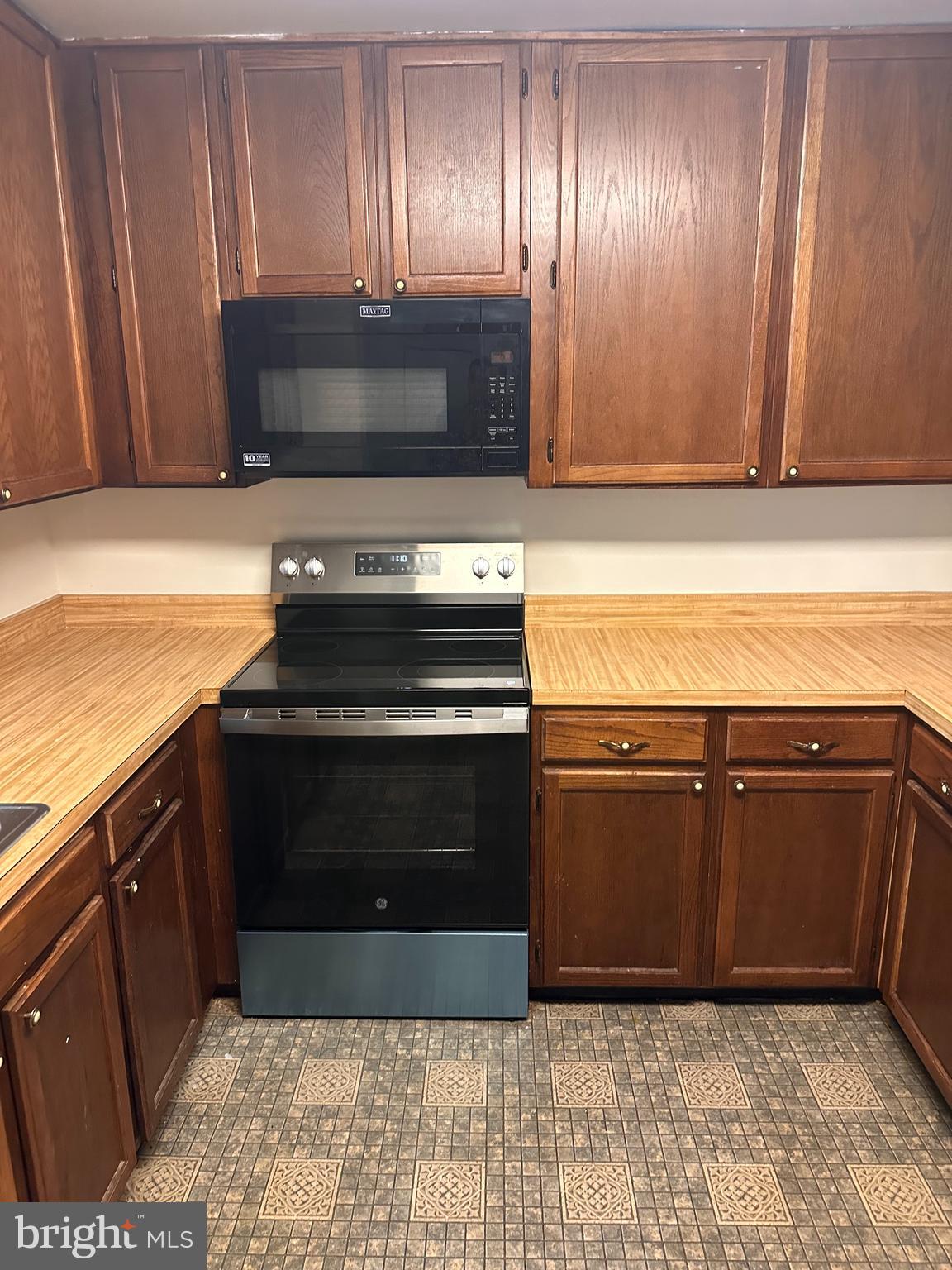 6937 Mayfair Terrace Laurel, MD 20707 - Photo 11 of 36 a kitchen with granite countertop stainless steel appliances and cabinets