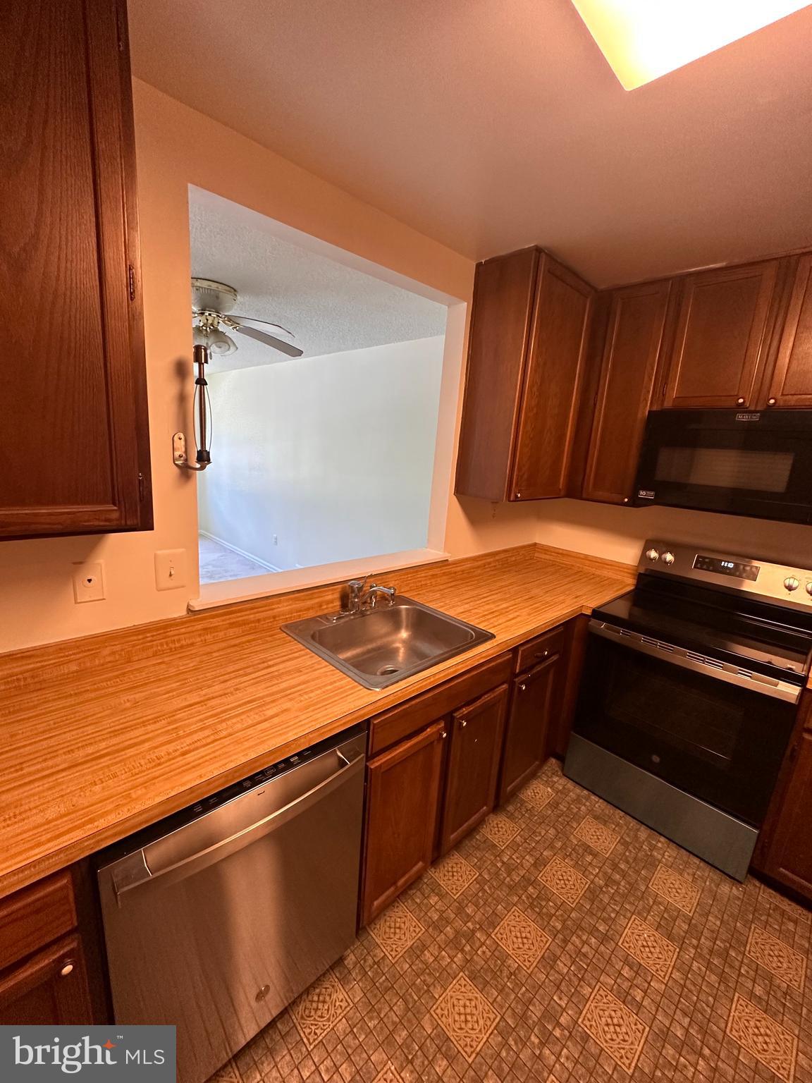 6937 Mayfair Terrace Laurel, MD 20707 - Photo 12 of 36 a kitchen with stainless steel appliances granite countertop a stove and a sink