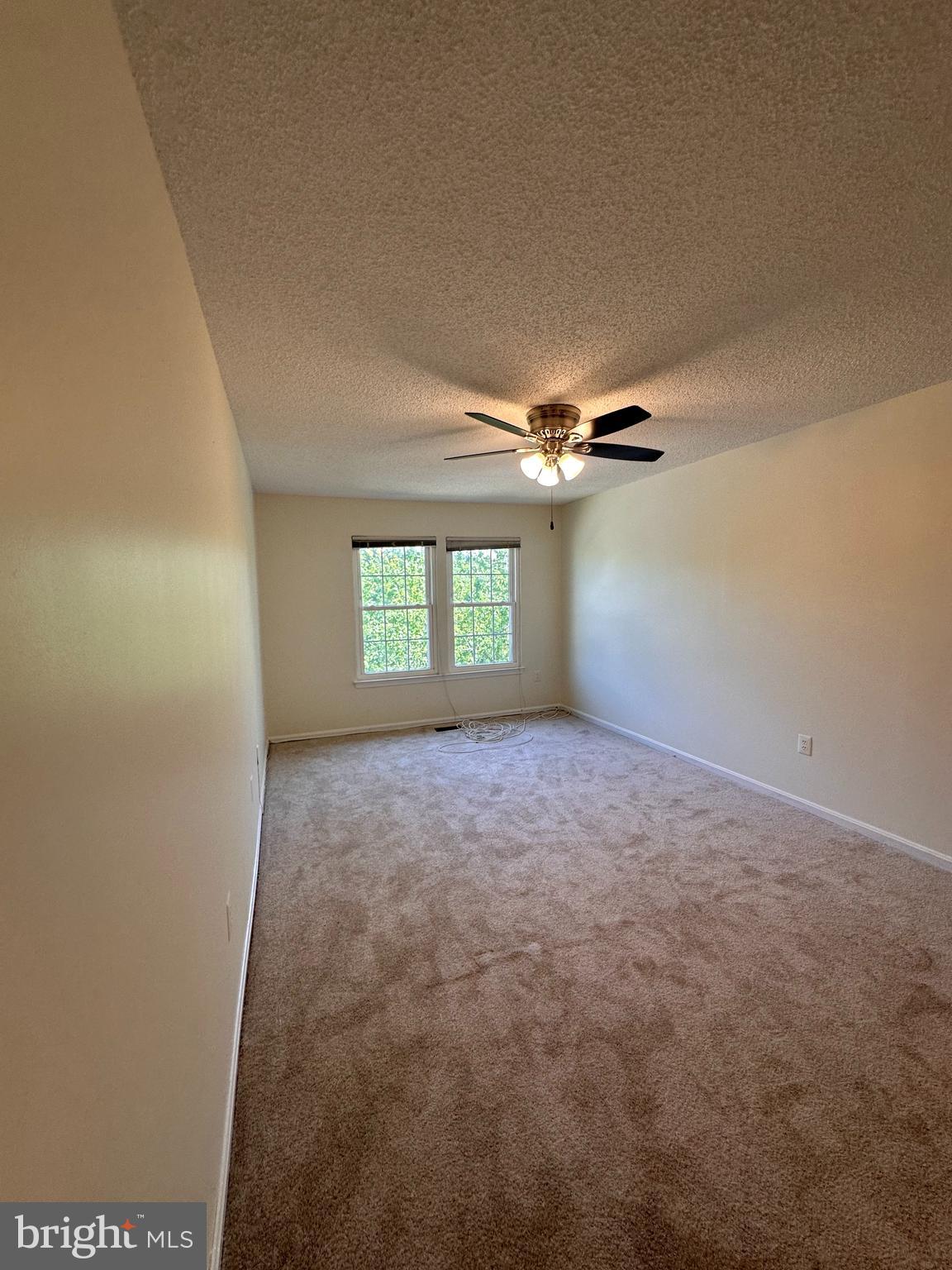 6937 Mayfair Terrace Laurel, MD 20707 - Photo 24 of 36 an empty room with windows and ceiling fan view