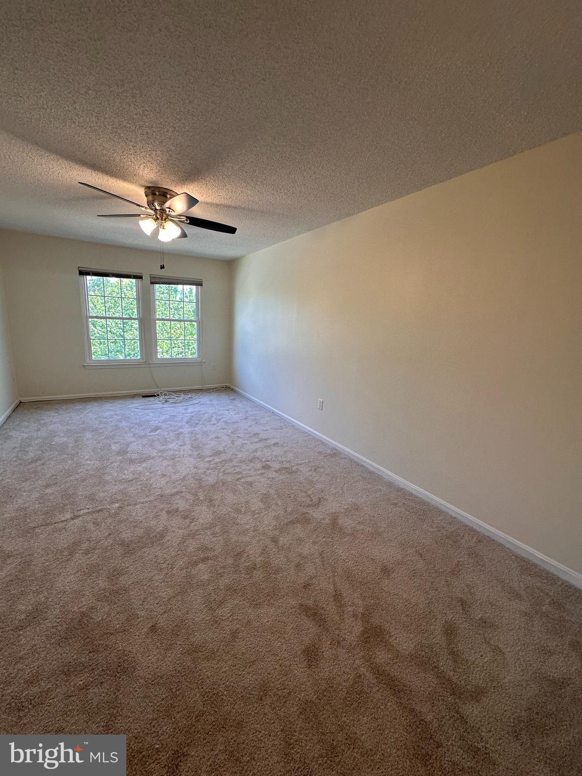 6937 Mayfair Terrace Laurel, MD 20707 - Photo 25 of 36 en empty room with windows and a ceiling fan