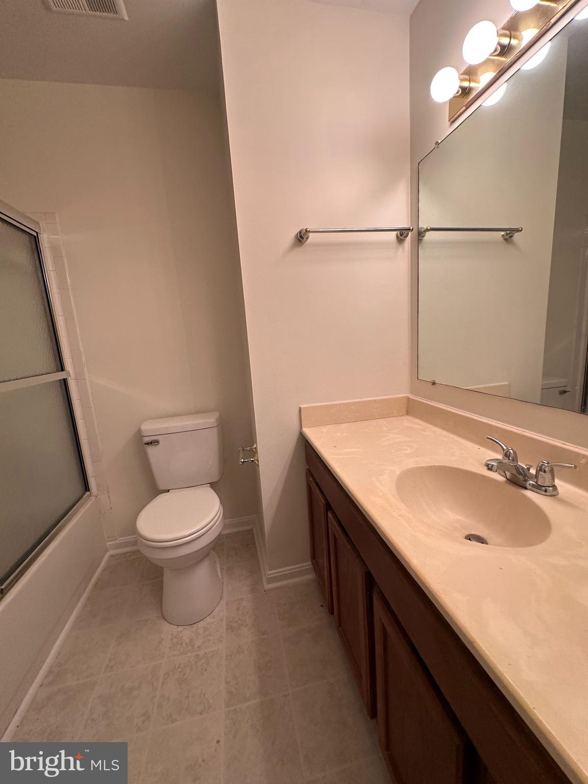 6937 Mayfair Terrace Laurel, MD 20707 - Photo 29 of 36 a bathroom with a granite countertop sink a toilet and a mirror