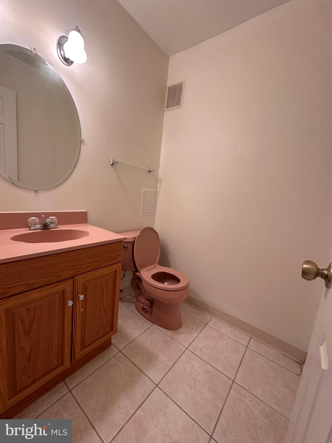 6937 Mayfair Terrace Laurel, MD 20707 - Photo 9 of 36 a bathroom with a sink a toilet and mirror