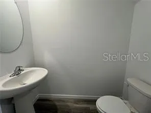 a bathroom with a sink mirror and toilet