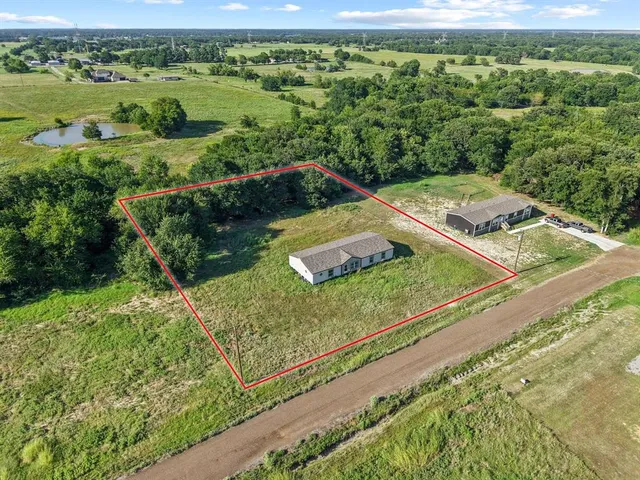 a view of a lush green outdoor space with a lake view