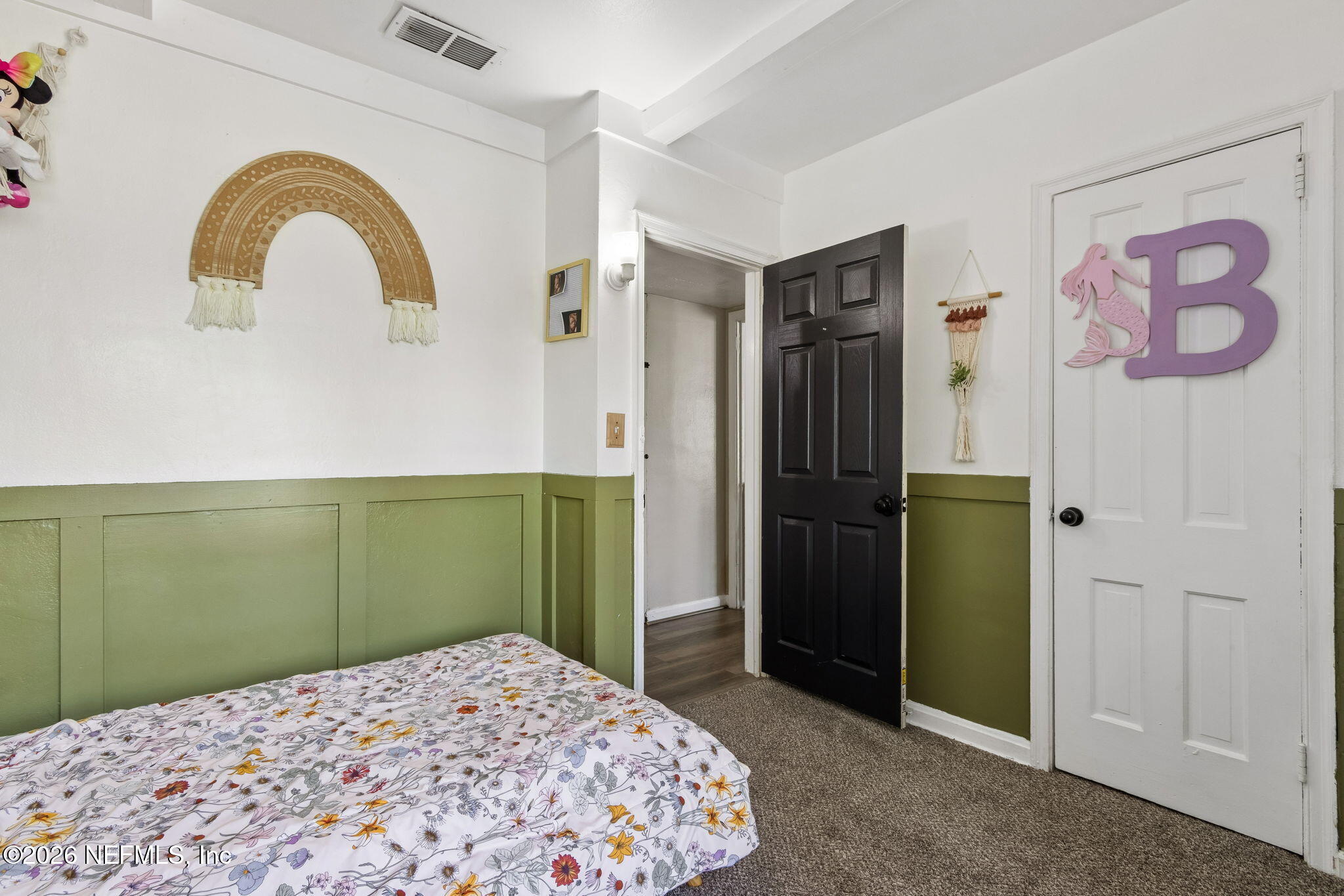 4816 Riverdale Road Jacksonville, FL 32210 - Photo 22 of 49 a bedroom with a bed and a painting on the wall