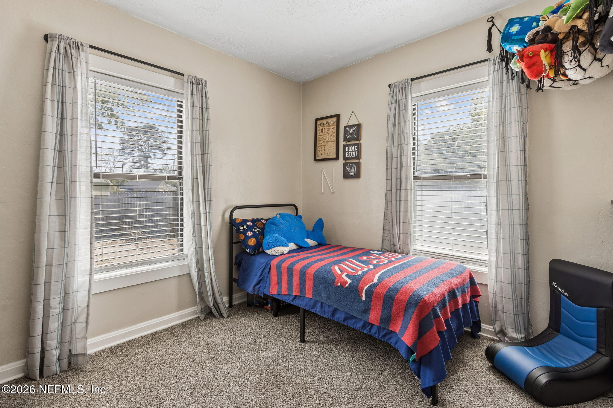4816 Riverdale Road Jacksonville, FL 32210 - Photo 23 of 49 a bedroom with a bed and a window