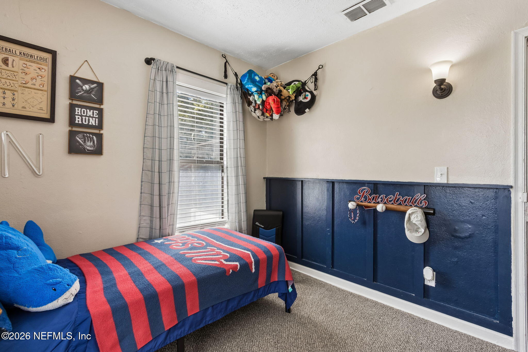 4816 Riverdale Road Jacksonville, FL 32210 - Photo 24 of 49 a bedroom with a bed and painting on the wall