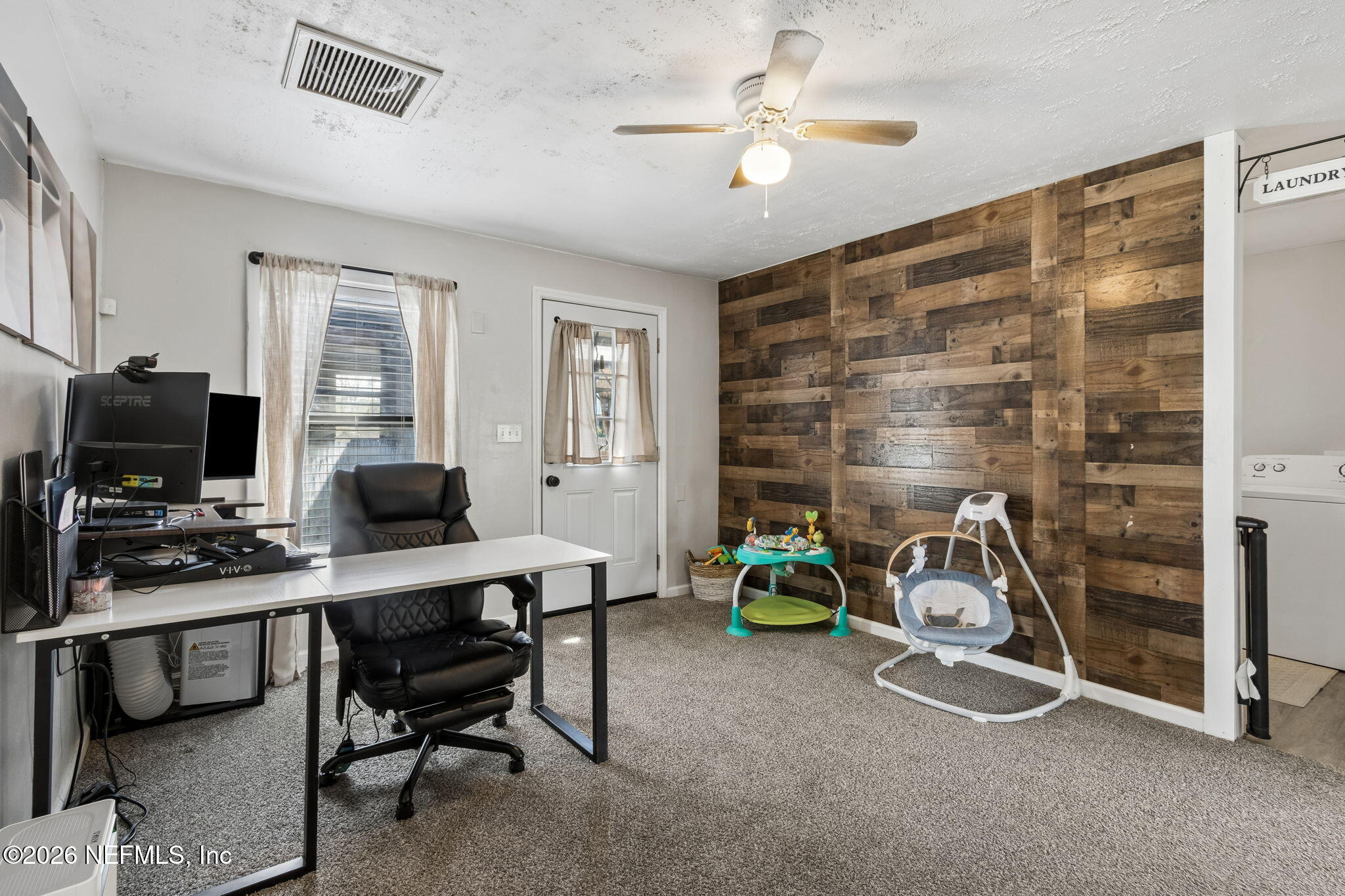 4816 Riverdale Road Jacksonville, FL 32210 - Photo 25 of 49 a view of a workspace with furniture and a window