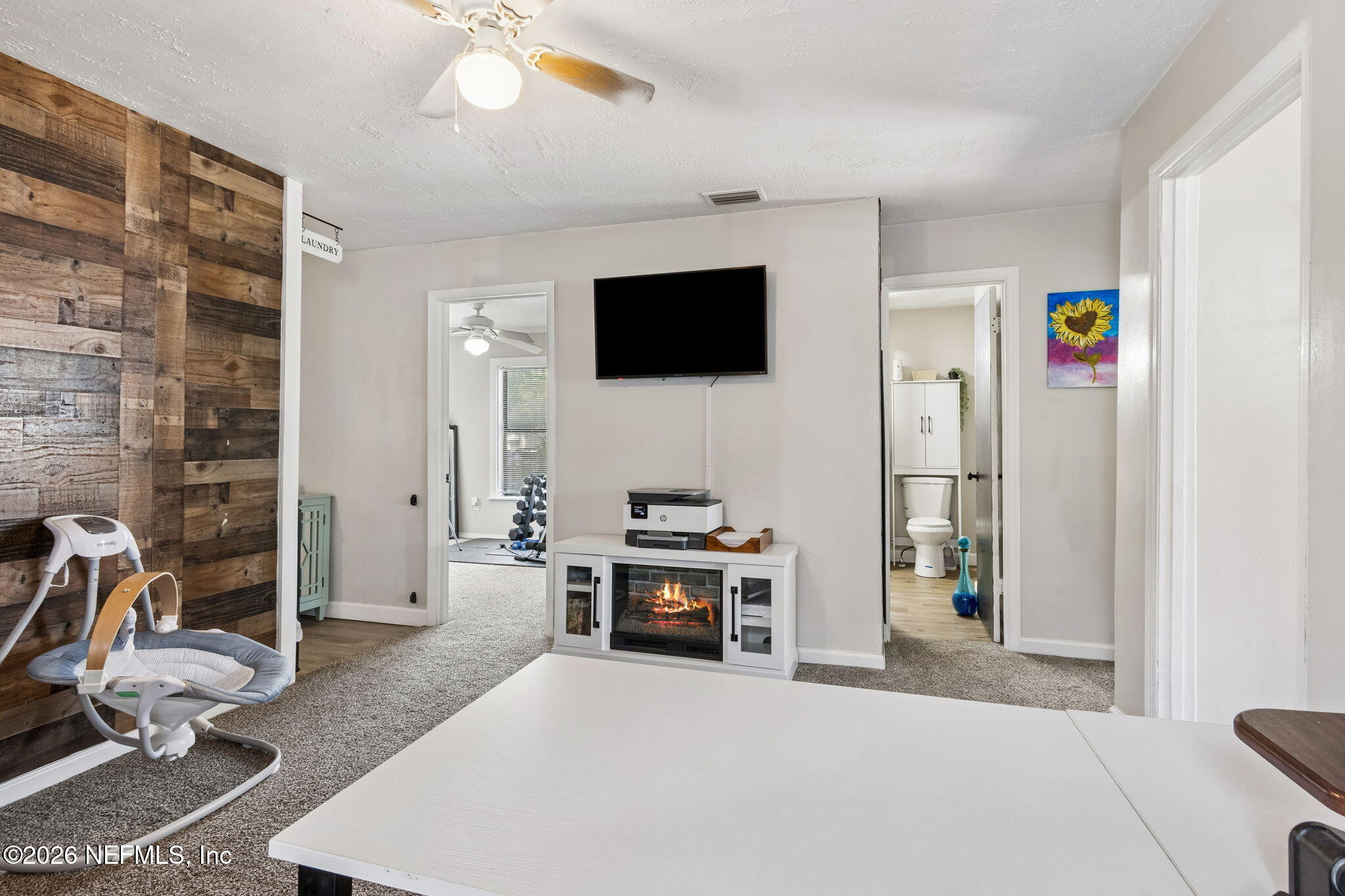 4816 Riverdale Road Jacksonville, FL 32210 - Photo 27 of 49 a living room with furniture and a flat screen tv