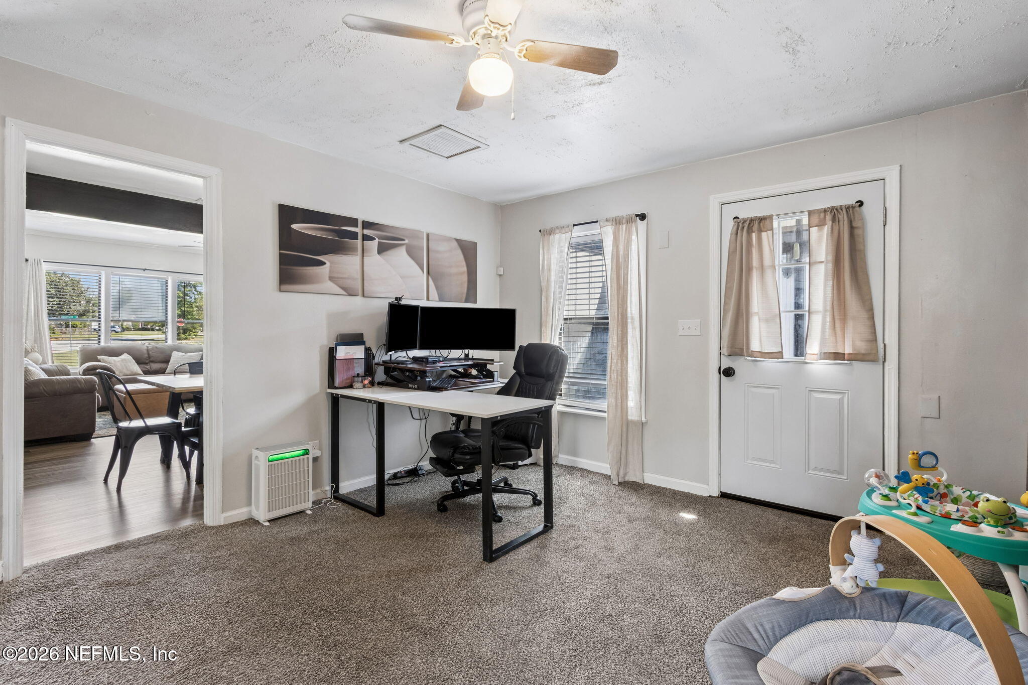 4816 Riverdale Road Jacksonville, FL 32210 - Photo 28 of 49 a living room with furniture and a flat screen tv
