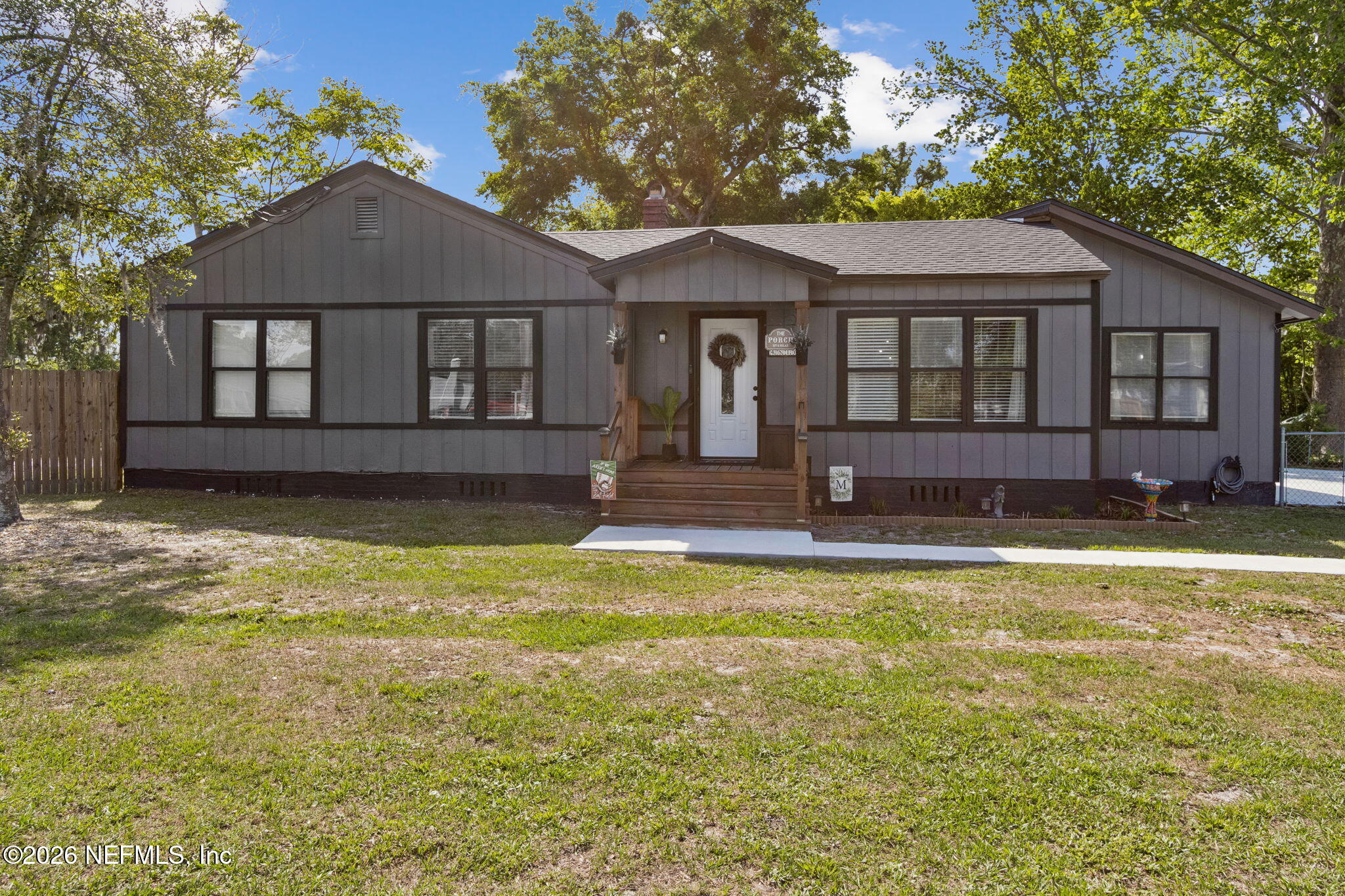 4816 Riverdale Road Jacksonville, FL 32210 - Photo 3 of 49 a front view of a house with a yard