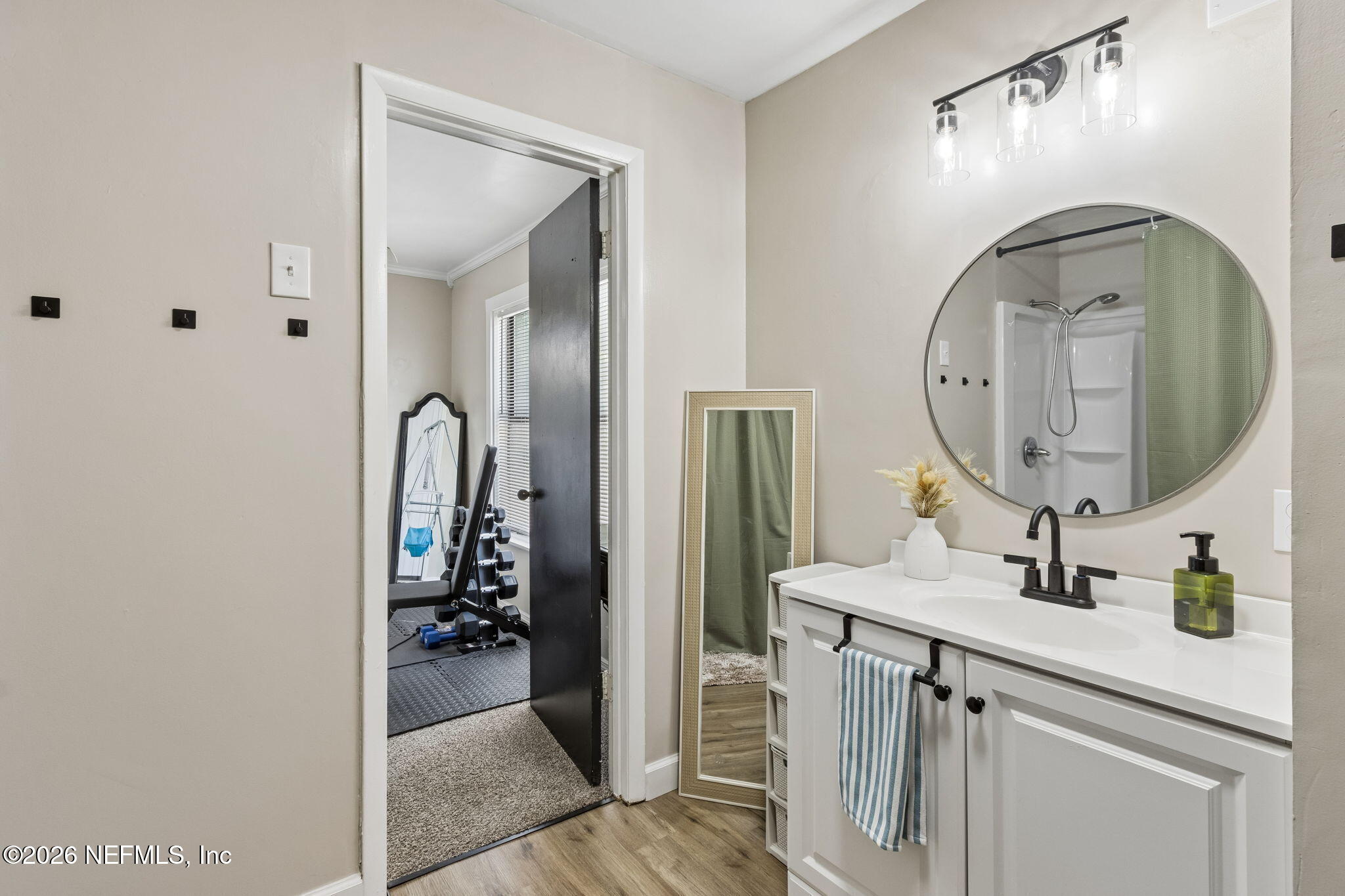 4816 Riverdale Road Jacksonville, FL 32210 - Photo 31 of 49 a en suite bathroom with a granite countertop sink a mirror and shower