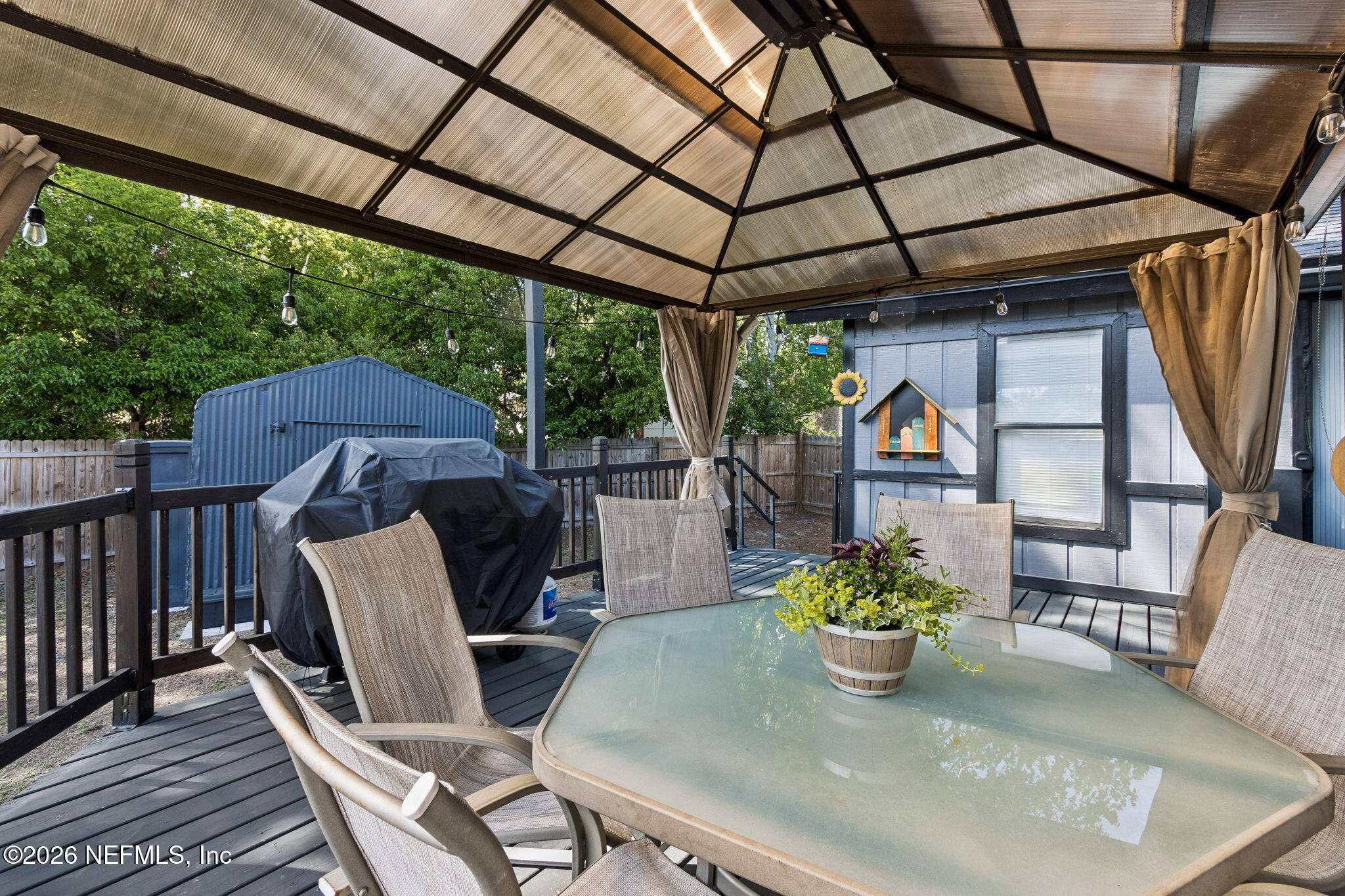 4816 Riverdale Road Jacksonville, FL 32210 - Photo 38 of 49 a view of a porch with furniture and a yard