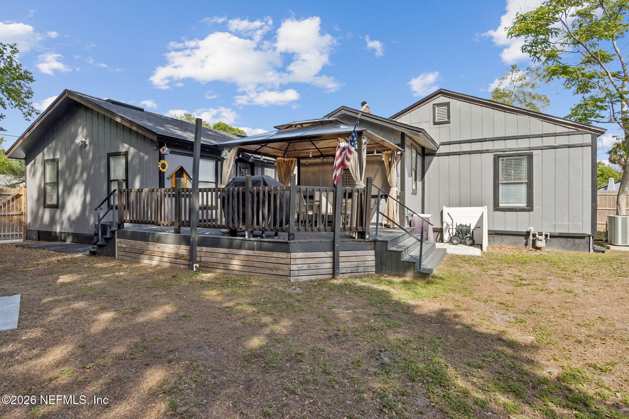 4816 Riverdale Road Jacksonville, FL 32210 - Photo 40 of 49 a view of a house with large trees and wooden fence