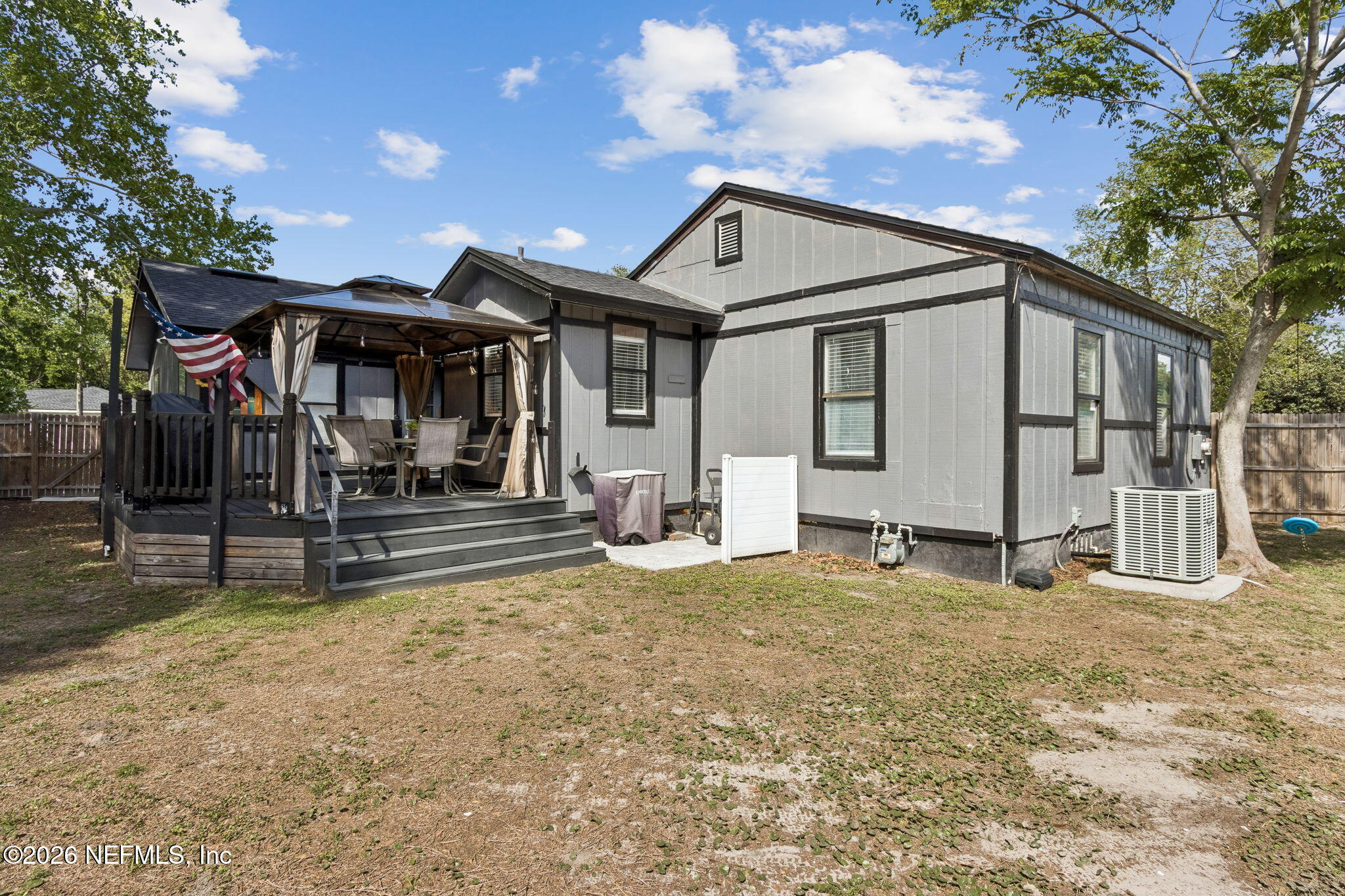 4816 Riverdale Road Jacksonville, FL 32210 - Photo 41 of 49 a view of a house with backyard and a tree