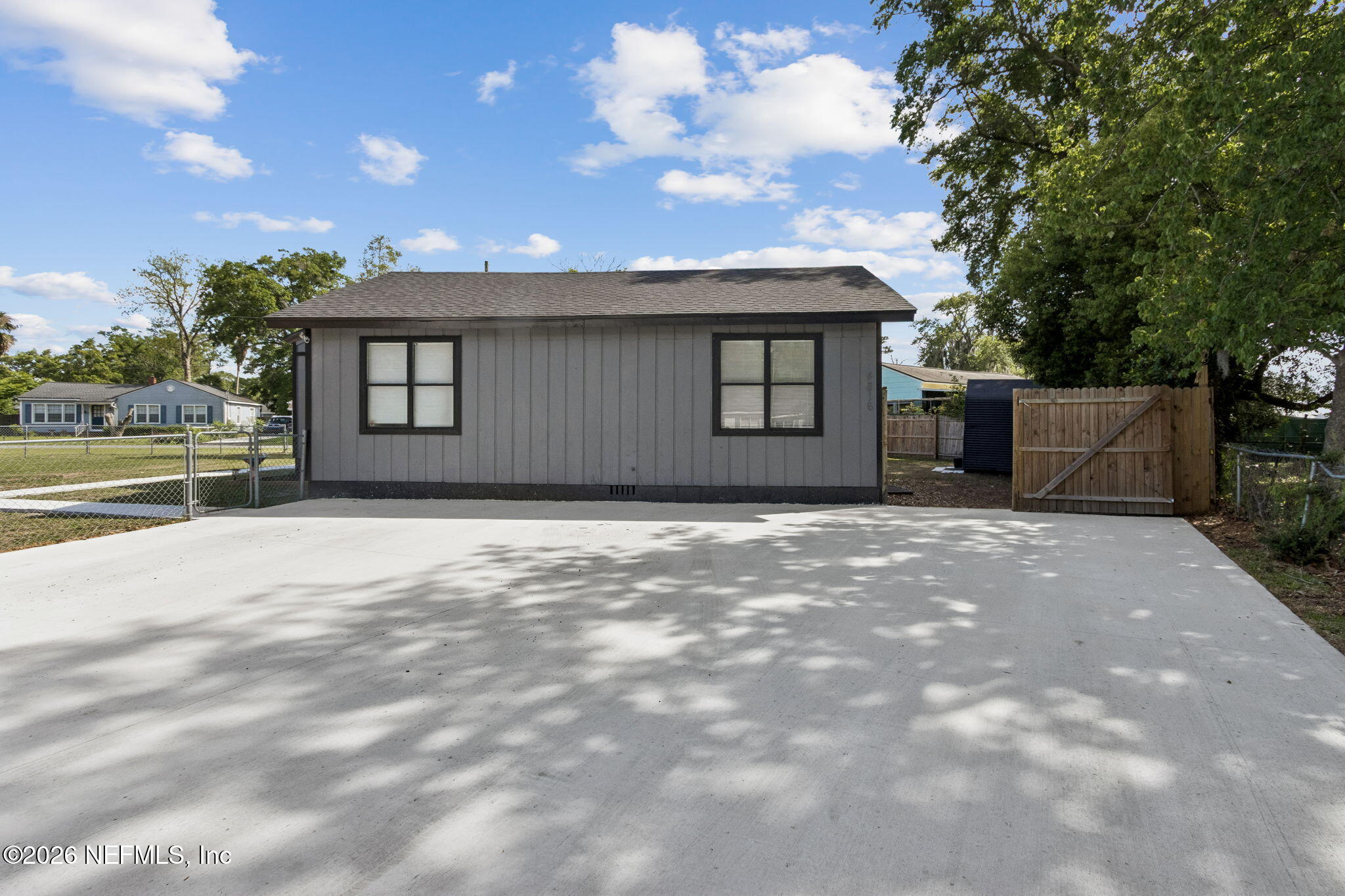 4816 Riverdale Road Jacksonville, FL 32210 - Photo 43 of 49 a front view of a house with a yard and garage