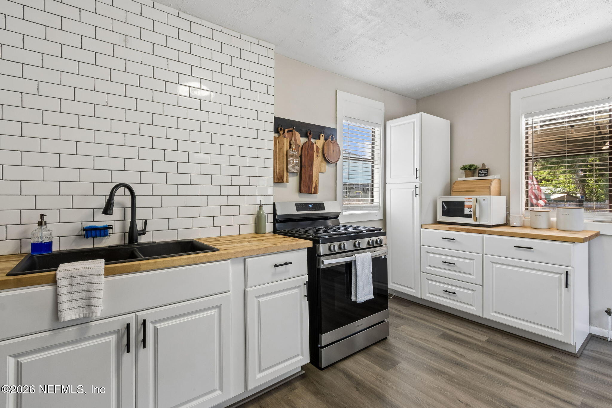 4816 Riverdale Road Jacksonville, FL 32210 - Photo 9 of 49 a kitchen with stainless steel appliances a stove sink and refrigerator