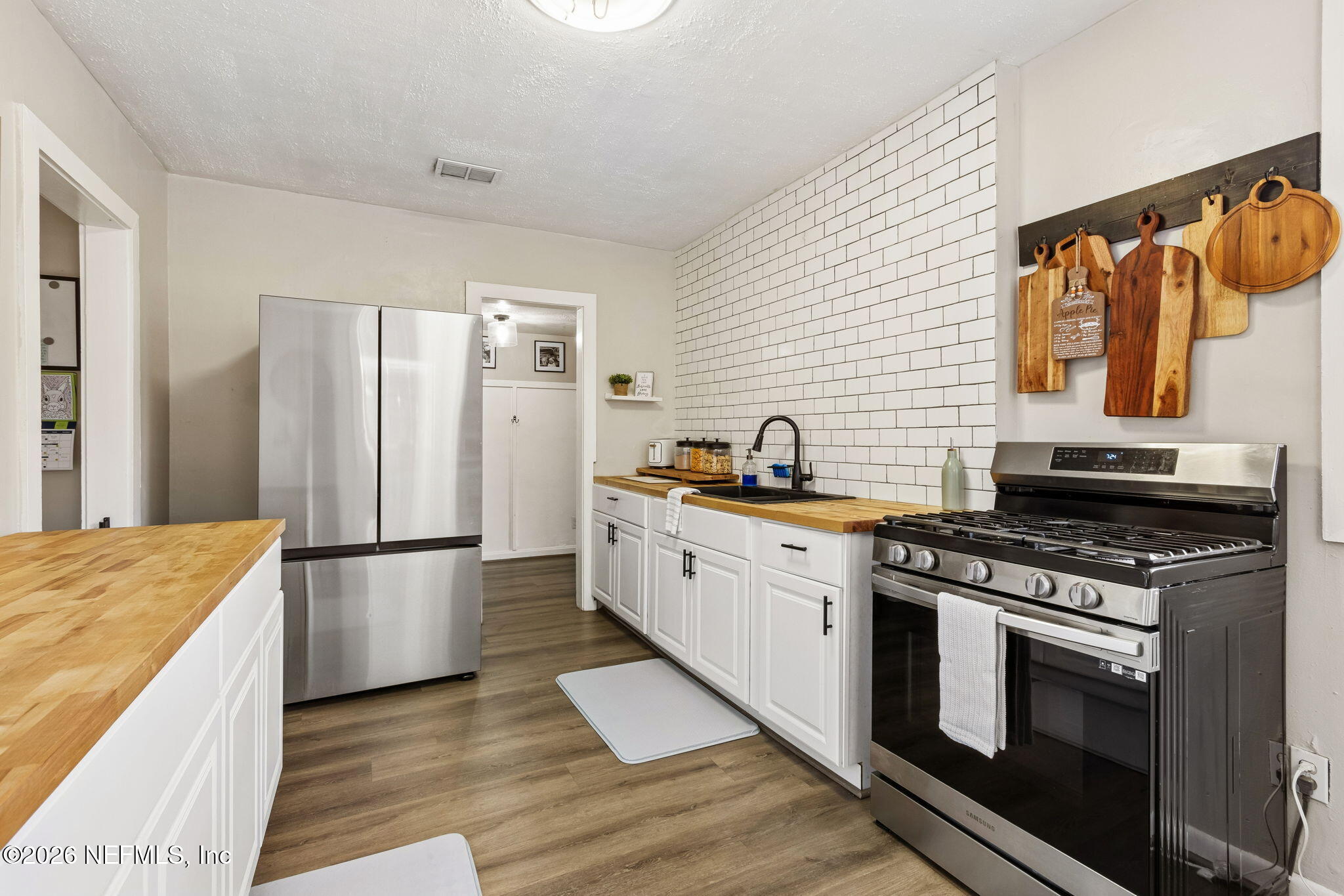 4816 Riverdale Road Jacksonville, FL 32210 - Photo 10 of 49 a kitchen with stainless steel appliances granite countertop a stove a sink and a refrigerator