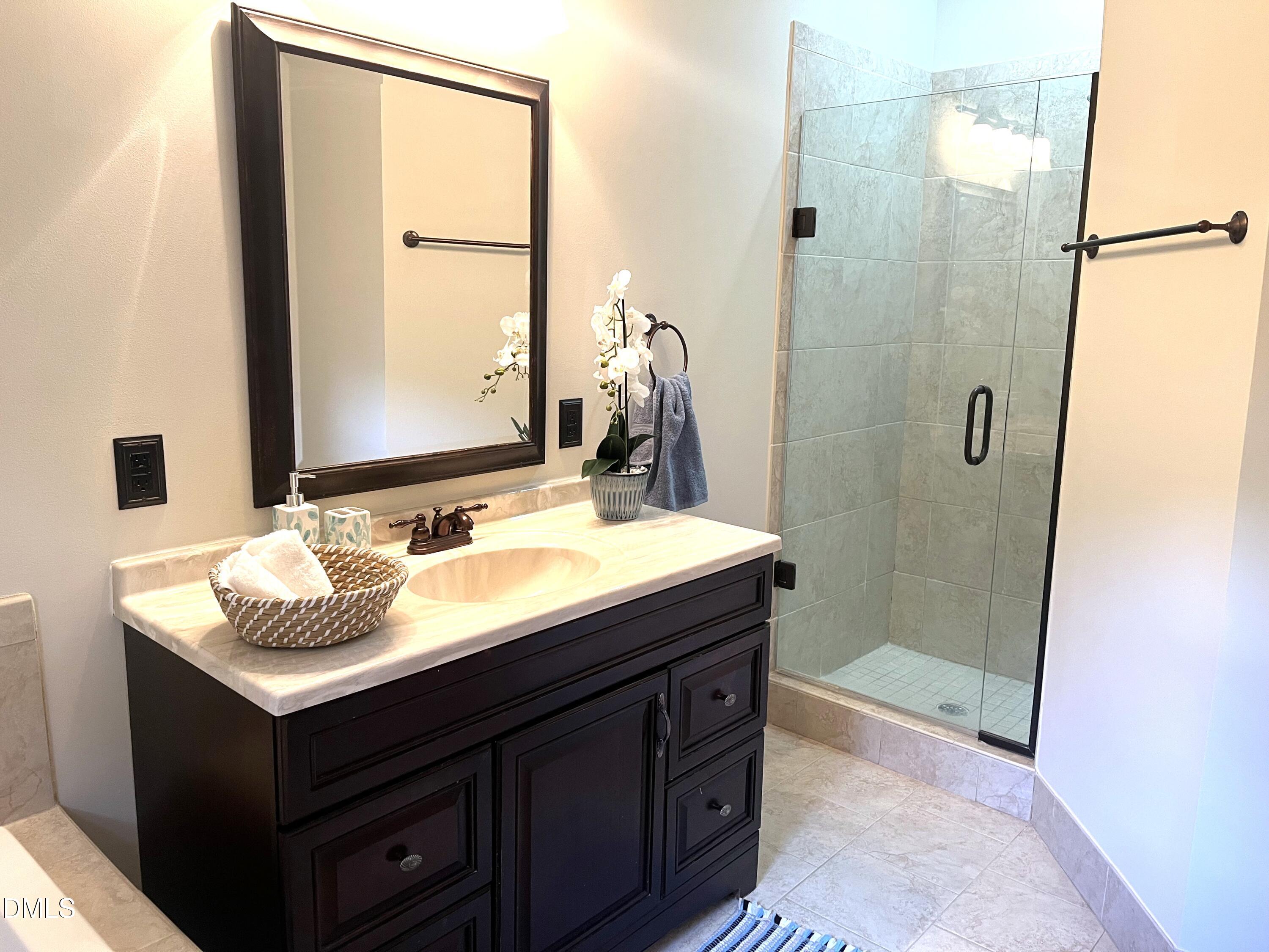 1707 Falls Church Road Raleigh, NC 27609 - Photo 12 of 22 a bathroom with a sink and a mirror