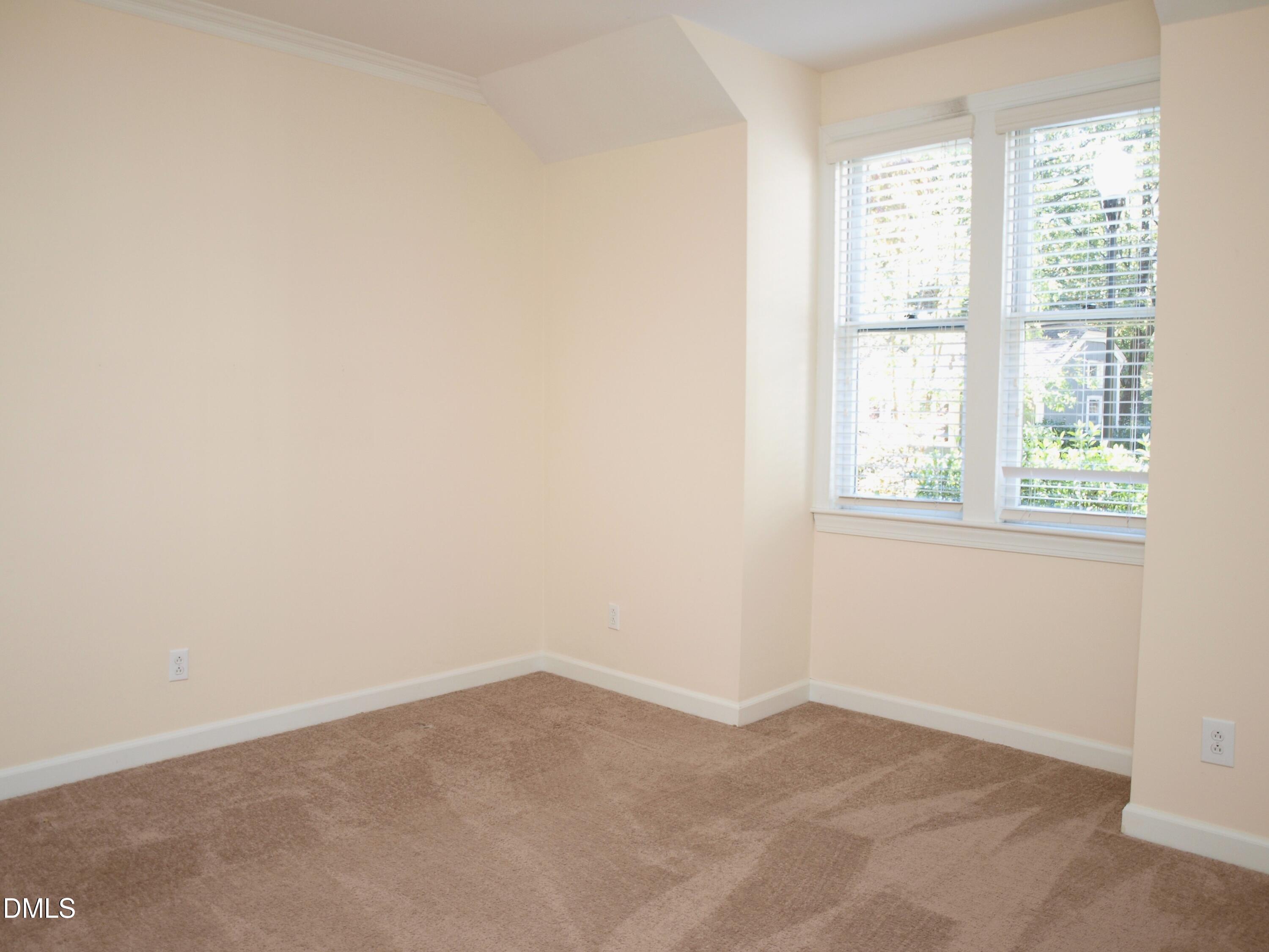 1707 Falls Church Road Raleigh, NC 27609 - Photo 14 of 22 an empty room with a window