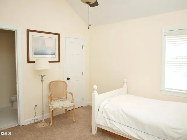 a bedroom with a bed and a chair