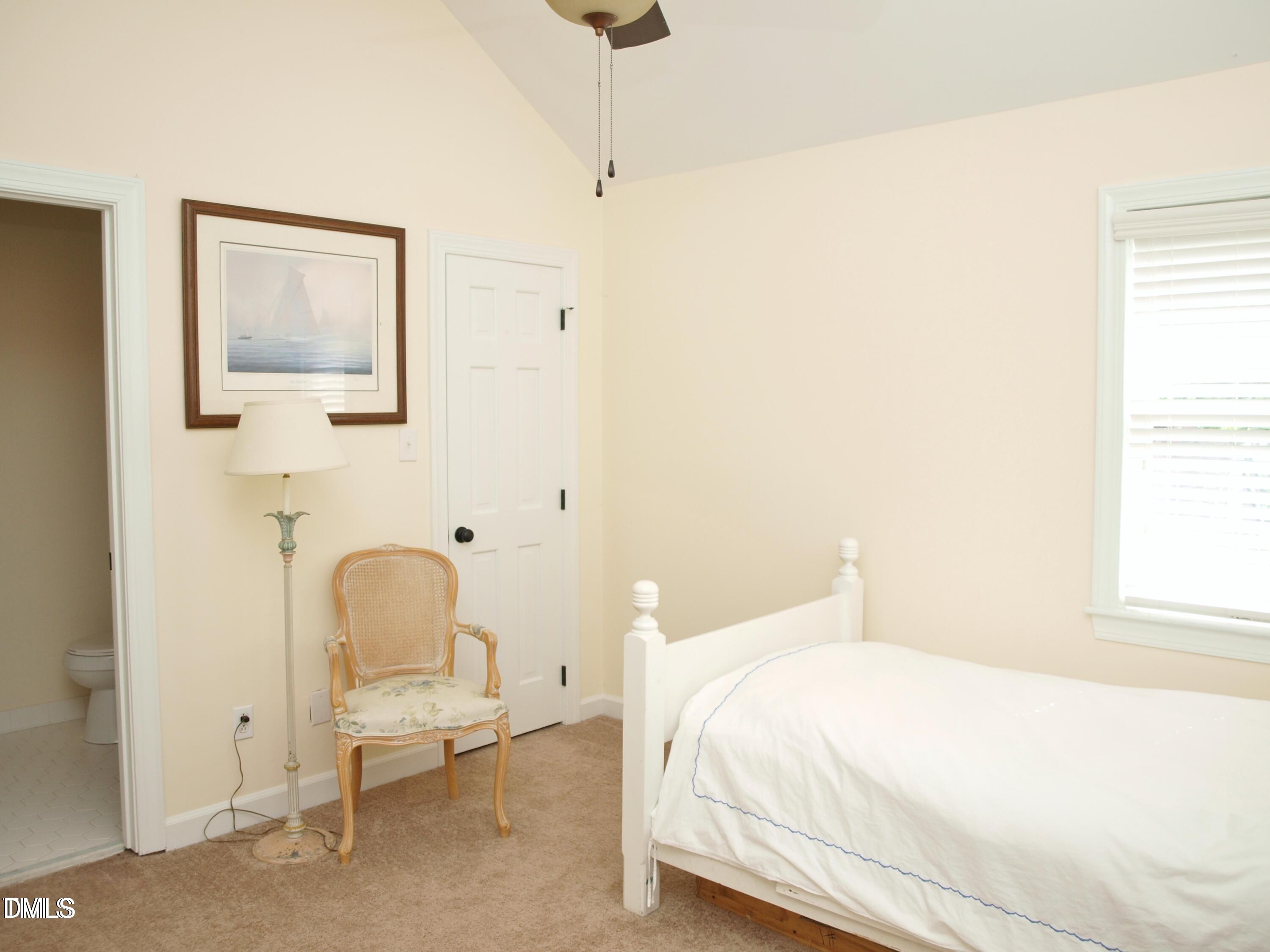 1707 Falls Church Road Raleigh, NC 27609 - Photo 16 of 22 a bedroom with a bed and a chair