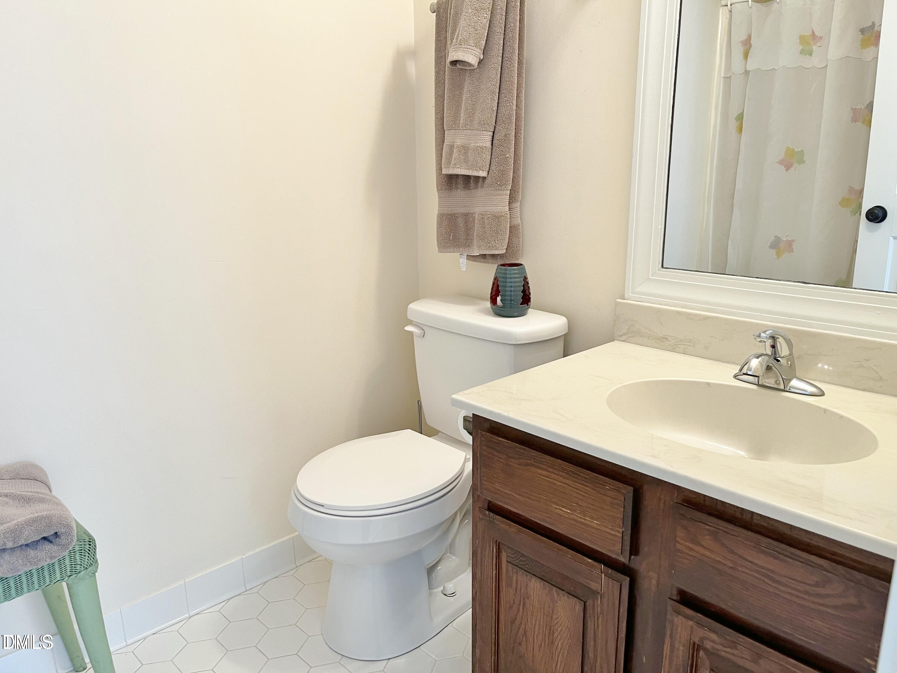1707 Falls Church Road Raleigh, NC 27609 - Photo 18 of 22 a bathroom with a sink and a toilet