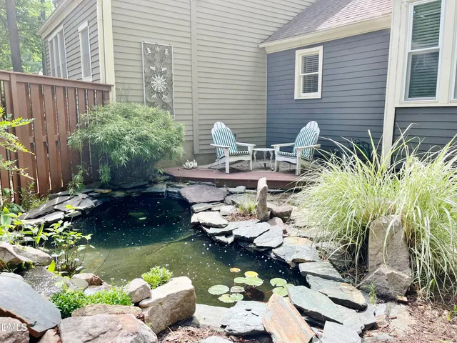 a front view of a house with a yard and a garden