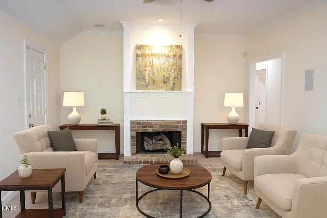 a living room with furniture a fireplace and window