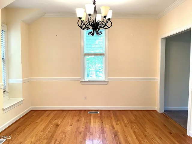 a view of a chandelier fan and wooden floor