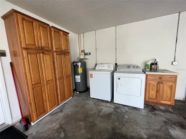 a view of a storage & utility room with dryer and washer