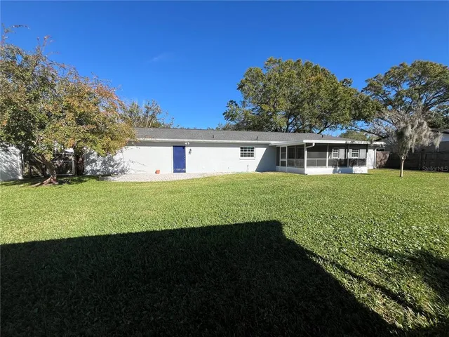 a view of house with garden space and trees