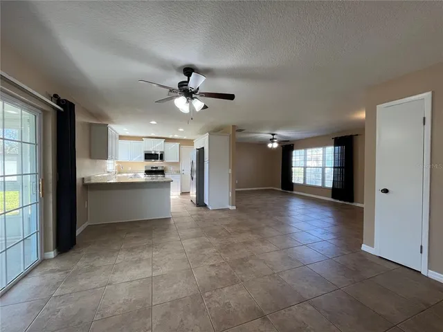 a view of a kitchen with a sink and a refrigerator