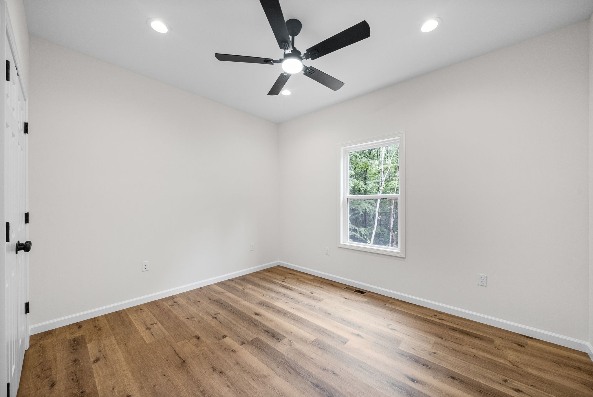 690 Brazzle Road Waverly, TN 37185 - Photo 22 of 35 an empty room with a window and a fan